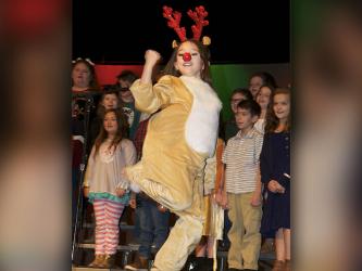 Rudolph the Red Nosed Reindeer, played by fifth grade student Morgan Nelson, made an appearance during the third grade performances and performed a hip hop number.