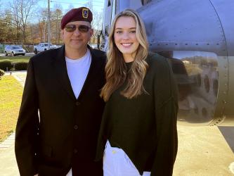 Sydney Petty is shown with Denton Petty in front of the Huey helicopter at the Veterans Memorial Park in Blue Ridge.