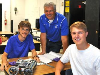 Fannin County High School teacher Bubba Gibbs, middle, is shown with two of his students, James Kyle, left, and Bryce Ware, earlier in the school year.