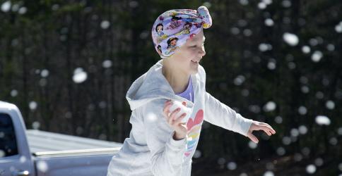 Aubrey Hutson pulls her hand back, loaded with a snow ball, to throw at her sister at their donated cabin in Copperhill Friday, January 14.