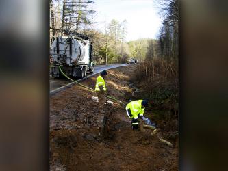 Marion Environmental Inc. was on site and fracking hazardous waste out of the drainage ditch just south of the entrance leading to the Toccoa River Swinging Bridge Wednesday, January 12, after a truck hauling concrete additive wrecked the previous day.