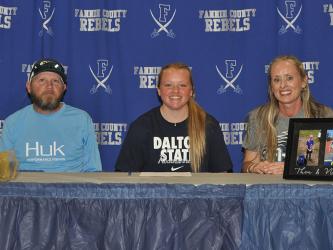 Fannin County High School women’s soccer player Mazie Goble smiles next to her father, Shannon Goble, and mother, Kristy Kouns, after signing her letter of intent to play soccer at Dalton State College. 