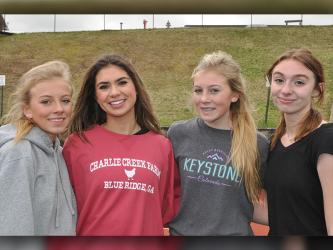 Shown, from left, are Carlee Holloway, Monica Cosentino, Lindsey Holloway and Caylee Gaddis just after running a timed 4x800 at practice March 9.
