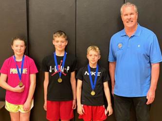 Three local youngsters placed in the annual Knights of Columbus Free Throw Championship in Atlanta. They were, from left, Taber Pass, Andrew Pero and Dawson Pittman. They are shown with Jack Devine who organized the event.
