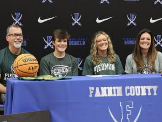 Reagan York, second from right, is all smiles after signing her letter of intent to play college basketball at Piedmont University. The signing ceremony took place Sunday, April 24, in the Fannin County High School gym. York is shown with from left, her father, Richard York, her brother, Hudson York, and her mother, Shannon York.