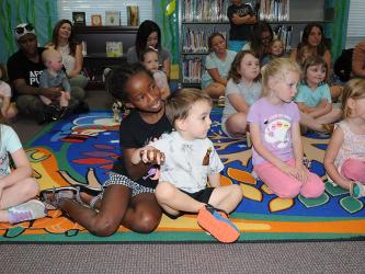 Youngsters paid close attention to Hannah Loudermilk (not shown) as summer programs kicked off at the Fannin County Public Library last week. Numerous events are planned throughout the end of July. 