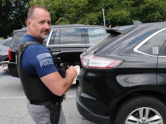 Blue Ridge Assistant Police Chief R.A. Stuart writes a citation for a car that has exceeded the three-hour parking limit in downtown Blue Ridge. The areas where the limit is being enforced are clearly market along East Main Street from Church to Mountain streets and along West Main Street from Mountain to Depot streets.