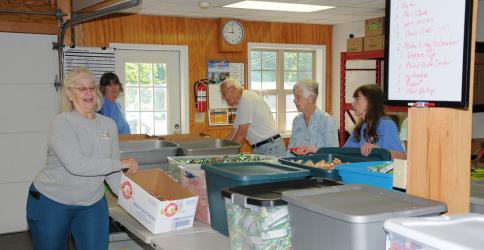 The Summer Meal Program Prep Crew was busy last week getting everything in order for 750 bags filled with meals for children to be packed. Another 160 family meal bags would also be prepared. The crew includes, from left, Kathleen Holt, Vicki Smith, Dave Tickner, Kathleen Tickner and Barbara Davenport.