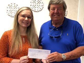 Tammy Grindstaff of United Community Bank presents the bank’s donation for Fire in the Sky to Lake Blue Ridge Civic Association representative Rick Glueckert.  