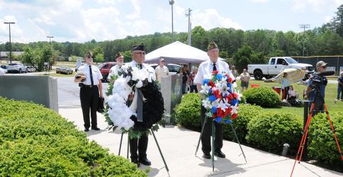The Memorial Day ceremony at Veterans Memorial Park honored those who have given the supreme sacrifice in the name of freedom. Veterans preparing for a portion of the event are, from left, front, Richard Crosley and D.R. Horton, and, back, Nick Wimberley and Steve Strickland.