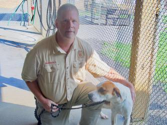 This sweet puppers is a male Hound mix who was found on 111 Albion Street in McCaysville June 15. He has a white coat with brown patches on his face. He is shown with Animal Control Officer Luke McDonald. View him using intake number 195-22.
