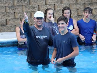 Matt Queen, left, North Central Georgia director for the Fellowship of Christian Athletes, explains the act of baptism before baptizing a smiling Vince Foster Tuesday, September 6. 