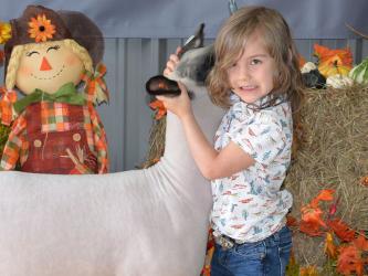 Stella Cotts, a Fannin County 4-H member, works to make her sheep behave during the Fannin County FFA Alumni Association Youth Fair Saturday, September 17, at the school system Agriculture Facility in Blue Ridge. 