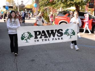 The Paws in the Park parade drew a huge crowd of owners and their pets to downtown Blue Ridge Saturday morning. These young ladies introduced the start of the event behind Fannin County Fire Chief Larry Thomas who led the parade with his truck blaring, “Who Let the Dogs Out.”
