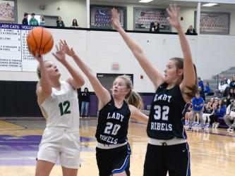 Ava Queen (20) and Macy Hawkins (32) attempt to block a shot by Pickens County’s Beth Hopkins in the first round of the ETC tournament in Ellijay. For more from the contest, please see B3.