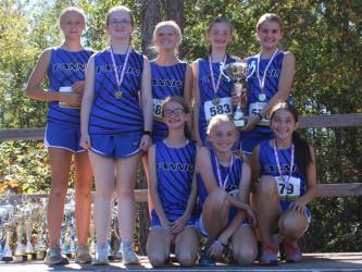 The Fannin County Middle School girls’ cross country team smile and hold their trophy as Georgia Grand Champions. Shown are, from left, back row. Kensley Pickelsimer, Claire Saxon, Karleigh-Jane Stiles, Lola Temples and Annaleigh Cheatham; and front row, Sydney Ford, Jacquelyn Cline and Sadie Patton. 