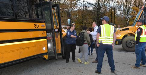 Fannin County Emergency Medical Services Director Becky Huffman and school system Assistant Superintendent Robert Ensley help move children from the Fannin County school bus involved in Tuesday’s crash to another bus.
