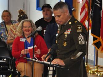 East Fannin Elementary Assistant Principal Andrea Cook is all smiles during special guest Sargeant Major Russell Blackwell’s speech for the school’s Veteran’s Day Program.