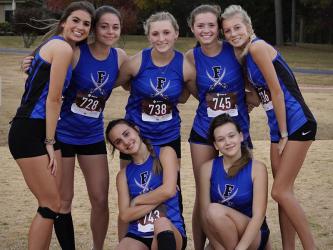 The Lady Rebels cross country team smiles together after earning first place in the Region 7AA Championship meet in Rome for the third year in a row Tuesday, October 25. Shown are, from left, standing, Monica Cosentino, Kristin Cipich, Shaylee Jones, Olivia Temples and Lindsey Holloway; and kneeling, Karli Sams and Jaclyn Cracknell. 