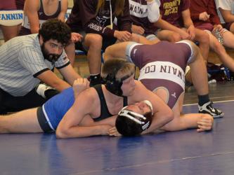 Carson Collis works to pin his opponent in his match against Swain County Friday, December 2. Collis was able to secure the pin and come out with a victory.