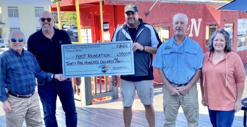 The Ferst Foundation, which provides books free of charge to some of Fannin’s youngest children, received a $3,500 donation thanks to the Blues & BBQ Festival. The free book effort is a project of the Kiwanis Club of Blue Ridge. Accepting the check from festival organizers were, from left, Steven Miracle and Troy Shirbroun of the Kiwanis Club and festival organizers Paul Gribble, Greg Spencer and Dena Martin.