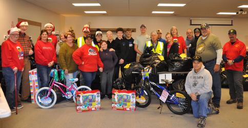 The Toys for Tots Christmas toy drive commenced Friday, December 16, at Family Connections when this group of volunteers were among those passing out the thousands of toys collected. Shown are, from left, front row, are Jody Guttridge, Dale Greene, Claire Bryant, Jan Carney, Cheryl Jordan, Olivia Coffone, Joel Warner, Brandie Forrestier and Greg Coffone. Second row, from left, are Ian Guttridge, Sue Warner, Dick Evelyn, Sheila Lenord, Thelma Coffone, Conner Kyle, James Kyle, Bryce Ware, Sam Jabaley, Gale Ma