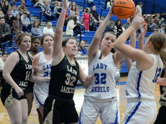 Macy Hawkins (32) fights for a rebound while Addison Smith (25) and Callie Ensley (12) look to help in Friday’s night region win over Rockmart. 