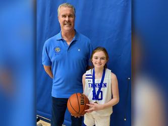 Addison Head won the 12 year old girls free throw competition. She is shown with Jack Devine of the Knights of Columbus, sponsors of the event.