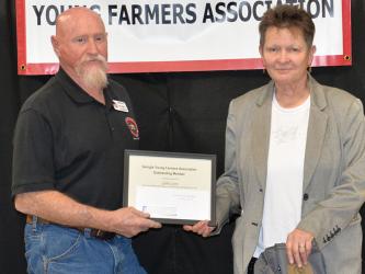 Fannin County Young Farmers Association President Kenny Queen presented Gilda Lyons the organization’s Outstanding Member award.