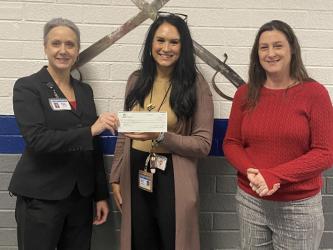 Martha Williams, from left, presented a Farm to School grant check to Kristen Stone and Amy Adams at Fannin County High School.