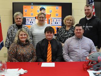 Addison Hook’s family joined him Wednesday morning, February 1, as he signed his Letter of Intent to play football for Union College. Pictured, from left, front row, are Courtney, Addison, and Jason Hook; and back, Billie Queen, Alex Johnson, Cindy Suits and Logan Suits.