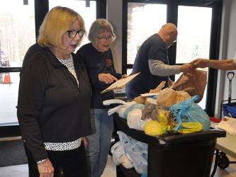 Sandy Cuppia, Sylvia Goodyear and Greg Duncan make sure bags are ready for delivery as part of the food ministry at Faith Presbyterian Church.