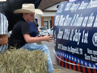 A hay bale made this young cowboy’s ride comfortable during the parade through McCaysville and Copperhill.