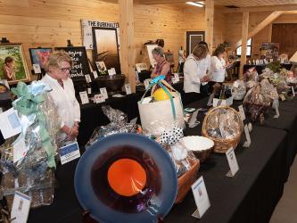 The silent auction at Paws for Celebration, the annual fundraiser of the Humane Society of Blue Ridge, attracted several bidders going after their favorite items.