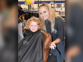 Celeste Lance gets ready to cut Addyson’s hair as part of the Back to School Bash at Fannin County High School Saturday. Sponsors estimated 450 students took advantage of the annual event which featured the free haircuts.
