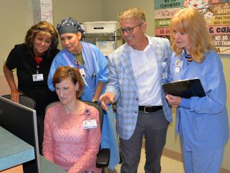 Blue Ridge Medical Center’s Jennifer Richbourg, director of nursing, seated, and standing. from left, Eva White, supervisor, Materials Management; Courtney Crain, CRNA; William Henry, chief executive officer, and Evelyn Hammond, director, Surgical Services review a patient’s progress following surgery at the hospital last week. “While the patient is here, we do what they need,” Richbourg said.
