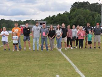 Shown during the Hometown IGA Legends of the Game presentation Friday night at Copper Basin High School are, from left: Toby Griffeth, Bree Muse, Austin Muse, Spence Griffith, Dylan Boggs, Andy Whitener, Beth Whitener, Bailey Stone, Trevor Stone, Jaidyn Griffeth, Maddox Griffeth, Leigh Griffeth, Jenny Muse, Parker Muse, Brad Muse, and John Spargo.