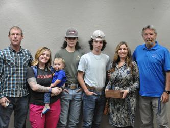 Chief Rob Stuart of Blue Ridge Police Department, together with Tony Cavallaro of The Vine in downtown Blue Ridge, presented each member of Brown’s family with their own challenge coin. Shown during the presentation are, from left, Brandon Quintrell, Chelsey Quintrell, Jaxson Quintrell, Mason Ramey, Brady Ramey, Kayla Fortenberry, and Brown’s son, Dan Brown.