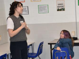 Ava Faries listens closely as Amanda Foody talks about her passion for writing with students at Fannin County Middle School (FCMS) last week. Foody is a New York Times best selling author who was invited to the school by Scott Moat, the media specialist at FCMS.