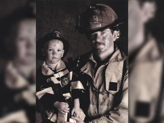 Both his grandfather and father had been firefighters and Geoffrey had long felt the desire to follow in their footsteps. A young Geoffrey Daves sits with his father, Jerry Daves, for a firefighter photo shoot.