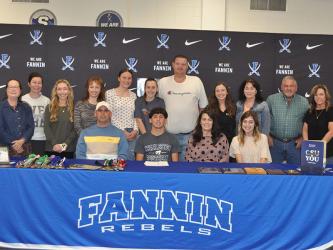 Zechariah “Zech” Prater (seated center) signed his Letter of Intent Friday to run track and field at Charleston Southern University. He was joined for his signing by, from left, seated, his father Shane Prater, his mother Ashley Prater, and his sister Rachel Prater. He was also joined by several members of his extended family. 
